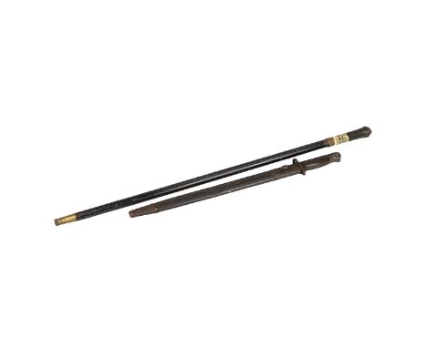 An Anglo Indian sword stick circa 1890, the slender blade sheathed in an ebonised stick, the handle decorated with carved bra