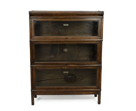 Globe Wernicke stacking lawyers bookcase. Three tiers with metal straps to side, up and over glazed doors, maker label to eac
