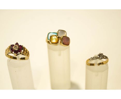 A 9 carat gold ruby and diamond cluster ring; with a mother of pearl set 9 carat gold ring; and an illusion set ring stamped 