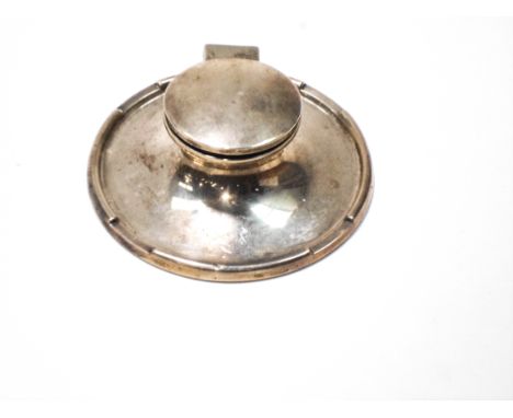 A silver capstan shaped inkwell, with a crenellated border and a ceramic liner, hallmarks for Birmingham 1919 by A & J Zimmer