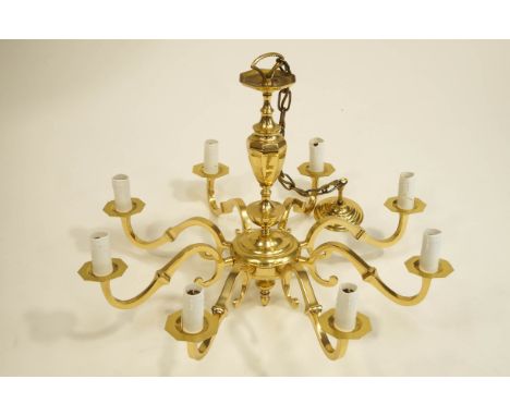 A modern brass eight branch ceiling light