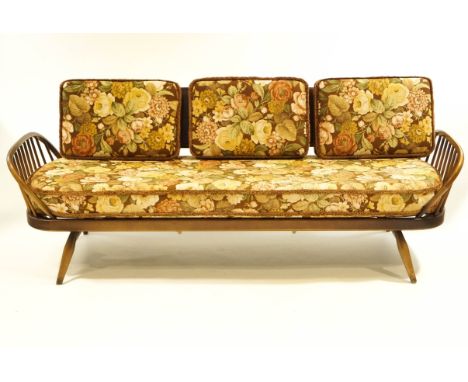 An Ercol beech and elm day bed, with floral patterned upholstery, 213cm long