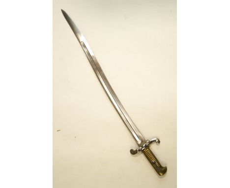 A bayonet with a brass ribbed grip, lacking scabbard, 70cm long