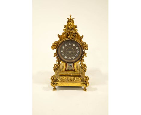 A 19th Century French gilt metal mantel clock, in the Classical style, the painted and enamel dial with Roman numerals, pendu