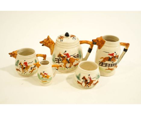 A Portland pottery five piece tea set, modelled with fox hunting scenes and the handle and spouts as foxs' heads and tails