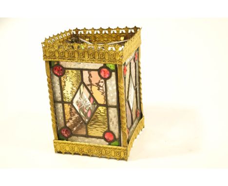 A decorative coloured and clear glass hall lantern, within a gilt metal frame, 33cm tall