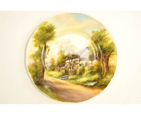 A Royal Worcester Cabinet plate, hand painted by R.Rushton, with a scene of Anne Hathaway's cottage, 26cm diameter