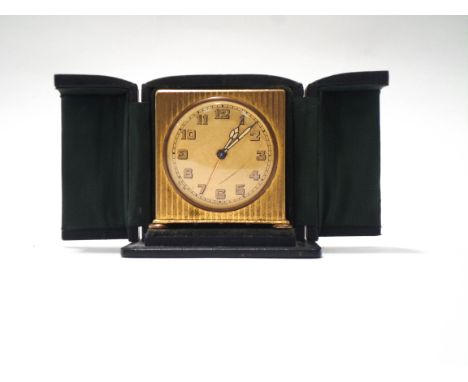 A Swiss boudoir clock, the rectangular gilded case with reeded decoration, circular dial with luminous Arabic numerals and ha