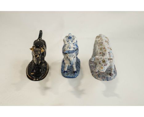 Three ceramic models of dairy cows as creamers, one with Delft style glaze decor, 20cm long
