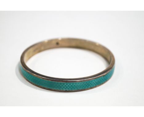 An early 20th Century silver and pale green guilloche enamelled slave bangle, hallmarked Birmingham 1924, the maker's mark in