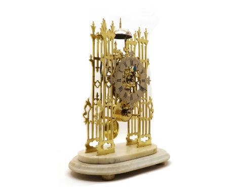 A brass cathedral skeleton clock,late 19th century, with a single fusee movement striking on a bell, raised on a marble base,