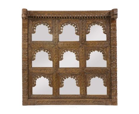 An Indian carved and mirrored panel, 162cm wide160cm highCondition report: Used as a headboard, knocks and chips to the frame