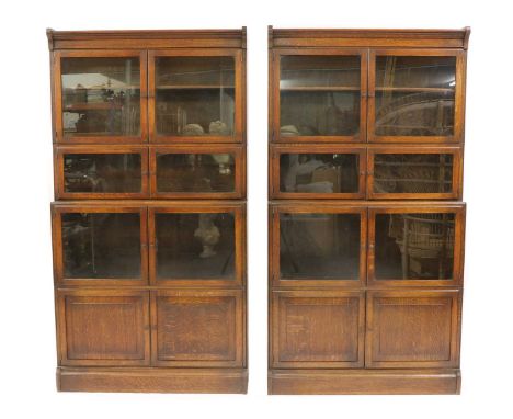 A pair of oak modular bookcases, 20th century, by Minty, with three glazed twin doors over a pair of panelled doors, labelled