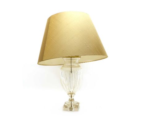 A glass table lamp and shade,of recent manufacture, the ovoid shaped lamp with fluted decoration on a square base, below a go