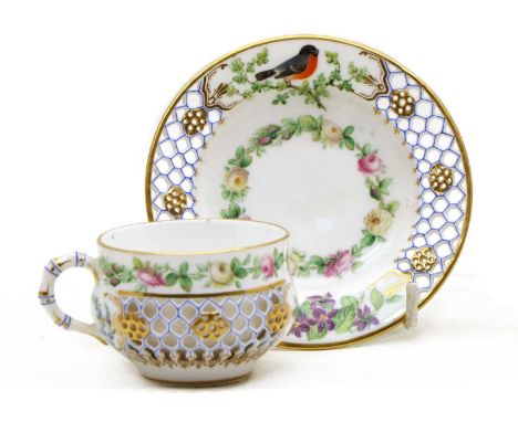 A Kerr & Binns Worcester reticulated porcelain cup and saucer, mid to late 19th century, in the style of George Owen, painted
