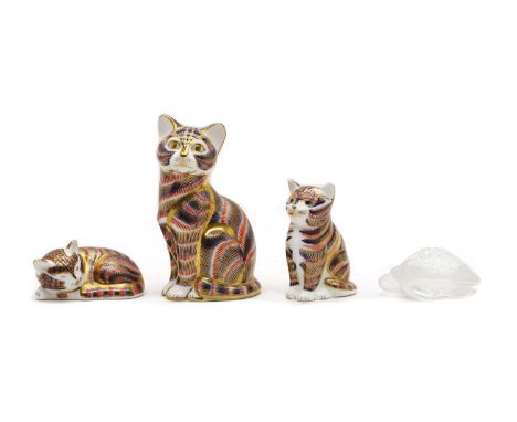 A group of three Crown Derby Imari figurines, each modelled as a cat decorated in the Imari palette, with gold stoppers and p