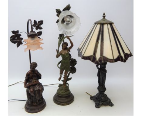 Tiffany style figural table lamp, leaded glass shade on cast metal base, H62cm, figural painted spelter table lamp with frill