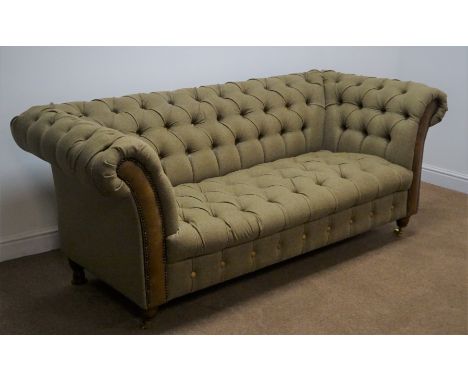 Large two seat Chesterfield style sofa, upholstered in Scottish wool tweed with leather fascias, turned supports on brass cas