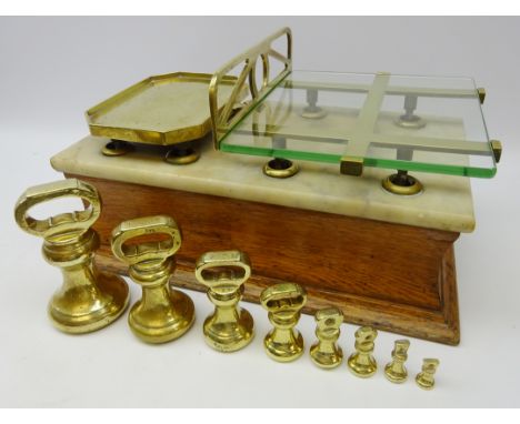 Set of 19th century oak counter top shop balance scales, marble top, openwork brass frame plate with glass insert, L52cm and 