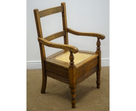 19th century country commode armchair, ladder back, daisy chain cane seat, on turned supports, W56cm Condition Report Click h