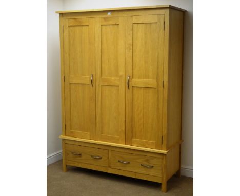 Solid light oak triple wardrobe, projecting cornice, three panelled doors enclosing hanging rail above two drawers, stile sup