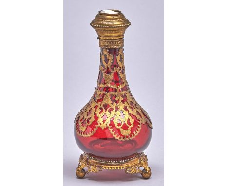 A Palais Royal giltmetal mounted ruby glass scent bottle, c1870, the cap inset with cameo of the head of a man, stopper, 18.5