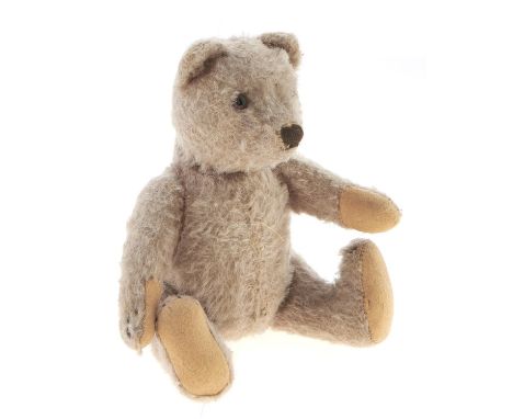 A Steiff teddy bear, mid 20th c, in faded mohair with felt pads, 19cm&nbsp; h  