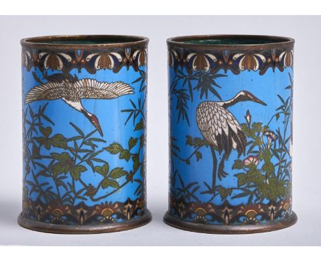 A pair of Chinese cylindrical cloisonne enamel vases, late 19th / early 20th c, with cranes and bamboo and other plants on a 