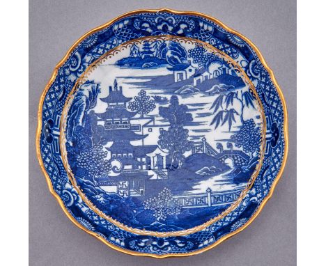 A Caughley saucer dish, c1782-92, transfer printed in underglaze blue with the Pagoda pattern and gilt, 21cm diam, printed S,