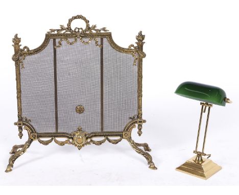 A brass and wire mesh firescreen, late 20th c, in Louis XVI style, 75cm h and an adjustable brass desk lamp, with emerald gre