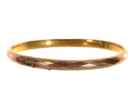 A gold bangle, early 20th c,&nbsp;90mm, marked 9ct, 11g  Split in one place