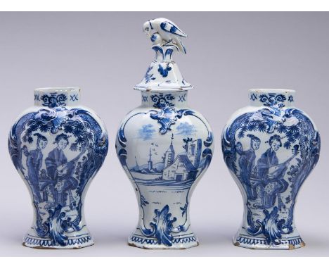 A Dutch Delftware garniture, 18th c, the three vases painted with a Chinese musician playing a lute, in moulded frame, the re