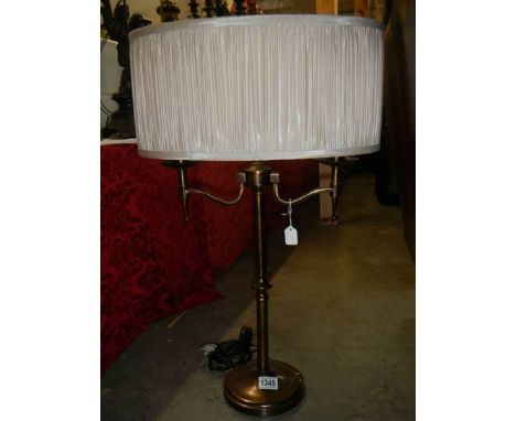 A two light brass table lamp with shade.