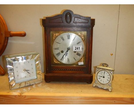 A 1930's mantel clock and two modern clocks.