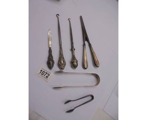 Two silver sugar tongs, 2 silver handled button hooks, silver handled glove stretchers etc.,