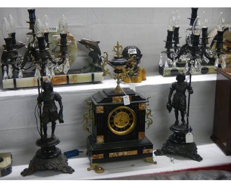 A three piece clock garniture the clock surmounted with an urn and the candelabra supported by figures, COLLECT ONLY.