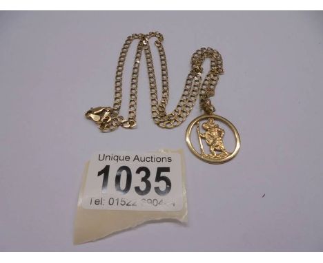 A 9ct gold St. Christopher with attached 9ct gold chain, 11 grams.