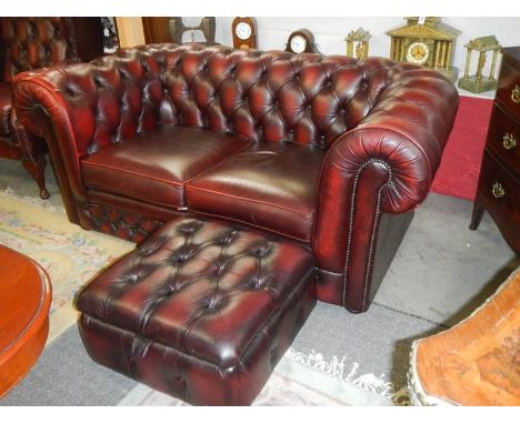 A two seat leather Chesterfield sofa with matching foot stool. COLLECT ONLY.