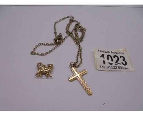 A 9ct gold cross on a plated chain and a cat charm.