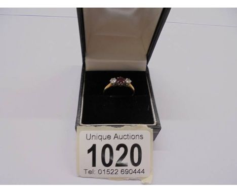 An 18ct gold set ruby and two diamonds, size M half, 1.8 grams.