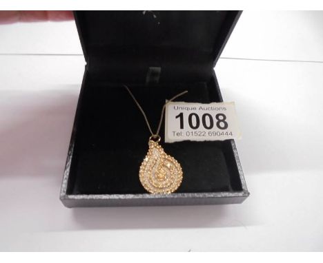 A yellow gold and diamond pendant, 6.9 grams.