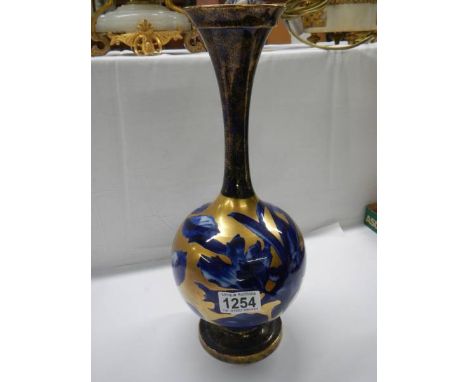 A blue and gold floral decorated vase.