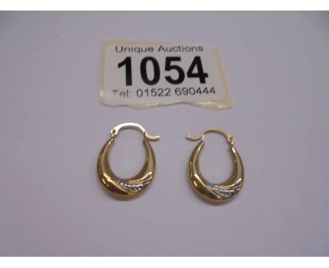A pair of 9ct gold earrings, 0.6 grams.