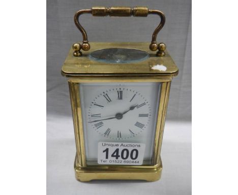 A brass carriage clock.