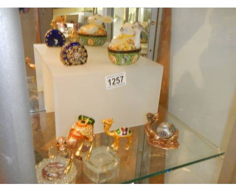 Three jewelled camel trinket boxes, a rabbit trinket box and a scent bottle.