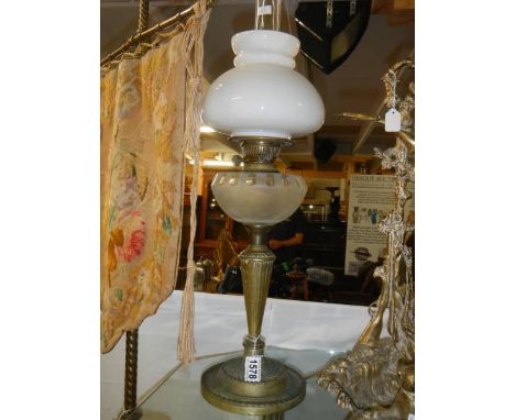 An oil lamp on brass base with glass font and shade. COLLECT ONLY.