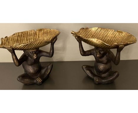 CHIMPANZE HOLDING BANANA LEAF TRINKET DISHES, a pair, contemporary, 33cm x 40cm x 18cm. (2) 