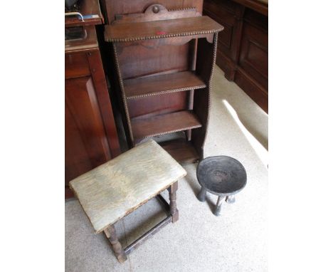 A mixed lot of furniture to include an African stool, a mahogany bookcase and an upholstery stool 