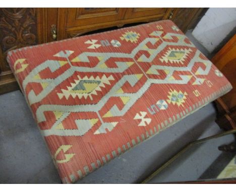 A large foot stool having Aztec design upholstery, 16" h x 47" w 