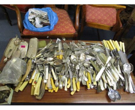 A mixed lot of silver plated cutlery to include fish servers, cake servers, miscellaneous knives and forks, bone handled kniv